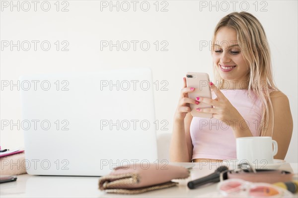 Blonde influencer using smartphone