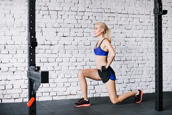 Blonde woman doing lunges