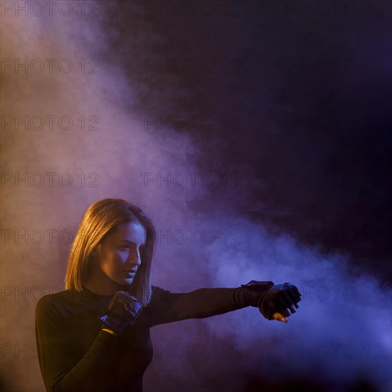 Boxing woman posing smoke