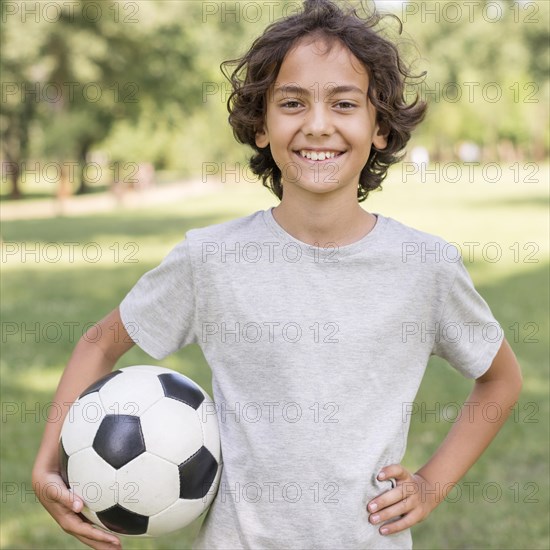 Boy playing with football ball