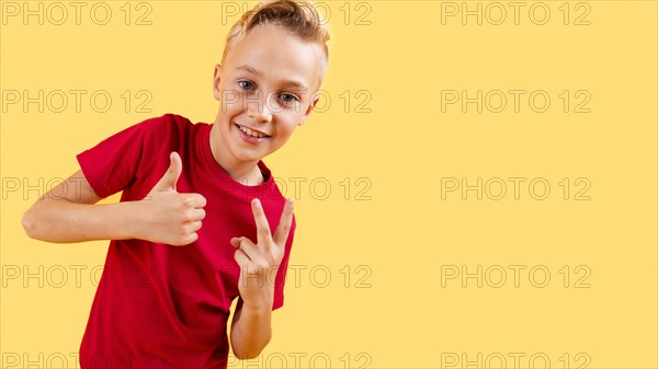 Boy showing ok sign peace with copy space