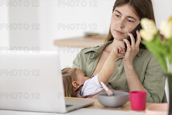 Busy mother with little kid