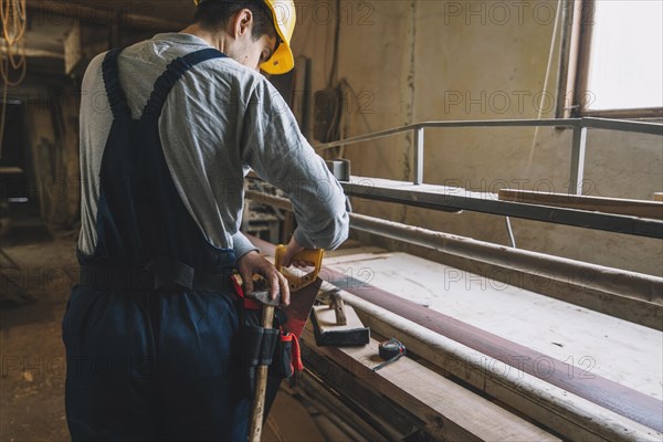 Carpentry concept with man working wood