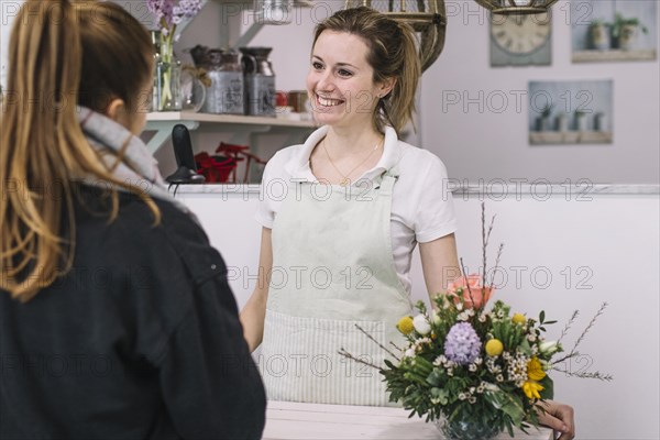 Charming florist talking with customer