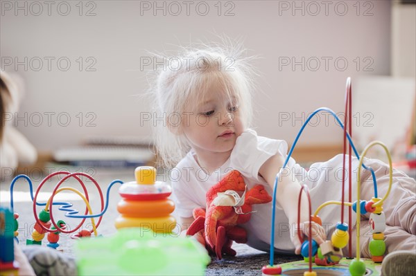 Charming kid with educational toys