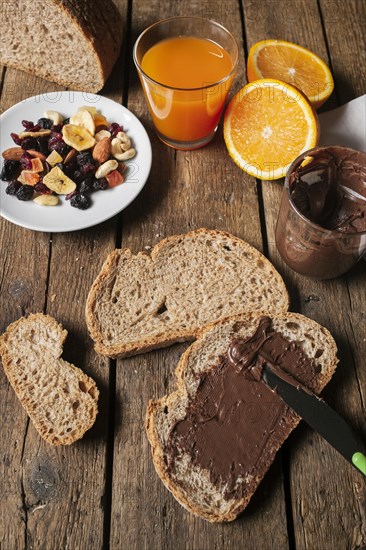 Chocolate spread bread slice with orange juice