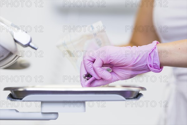 Close up dentist s hand holding dental tools