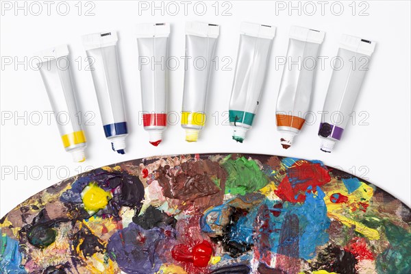 Close up dirty color palette watercolour tubes