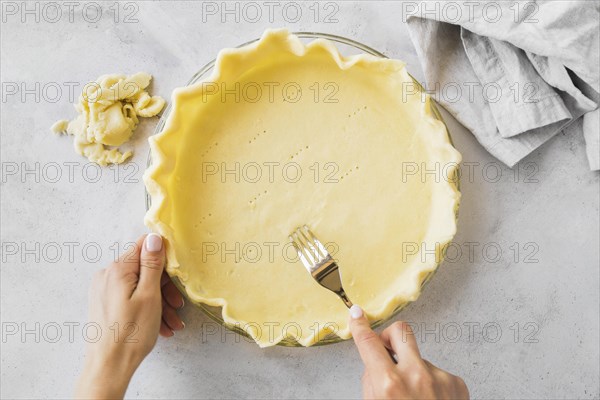 Close up hands preparing pie