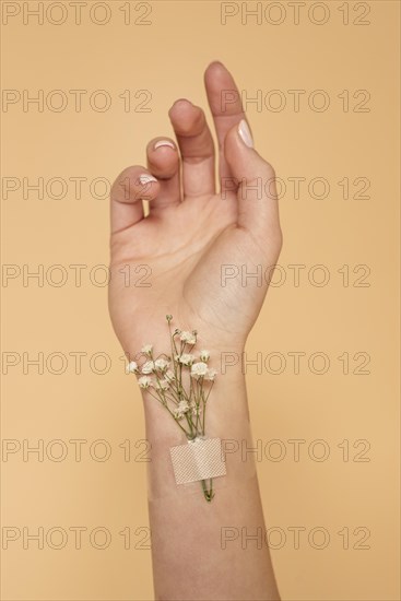 Close up hand with band aid flowers