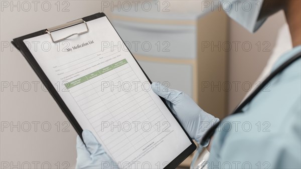 Close up health worker checking medication list