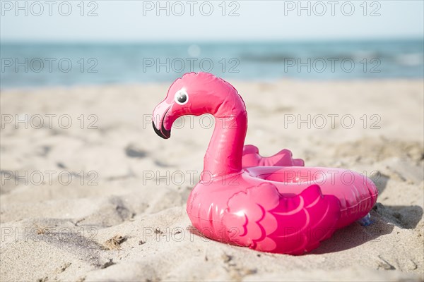Close up inflatble flamingo swim ring beach