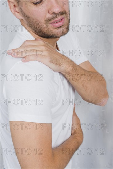 Close up man having pain his shoulder