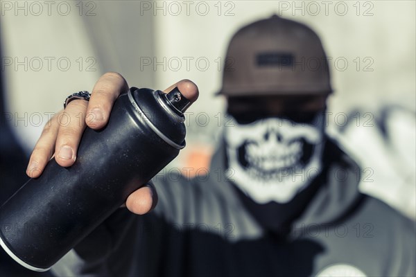 Close up man s hand holding black aerosol can