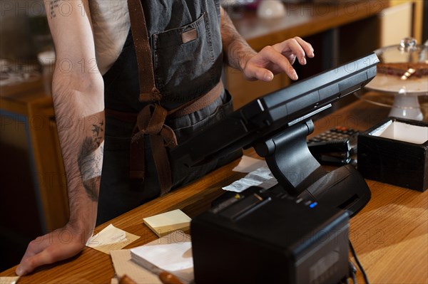 Close up man working cash register