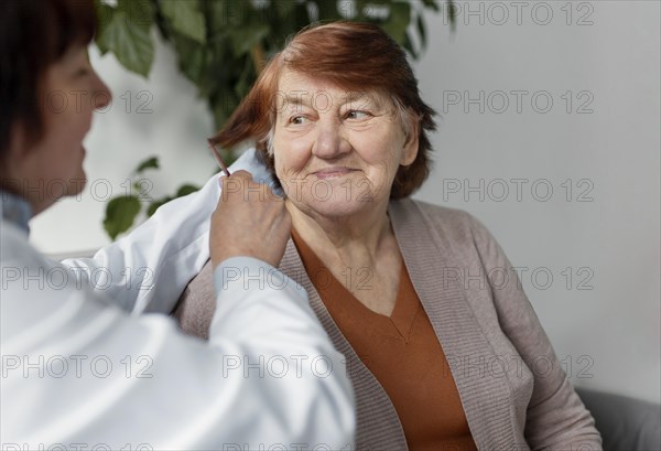 Close up nurse brushing woman hair