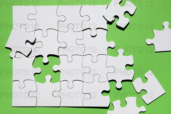 Close up puzzle piece green background