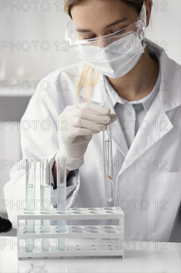 Close up scientist holding tube