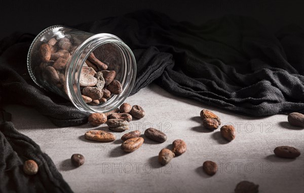 Close up spilled jar with cocoa beans