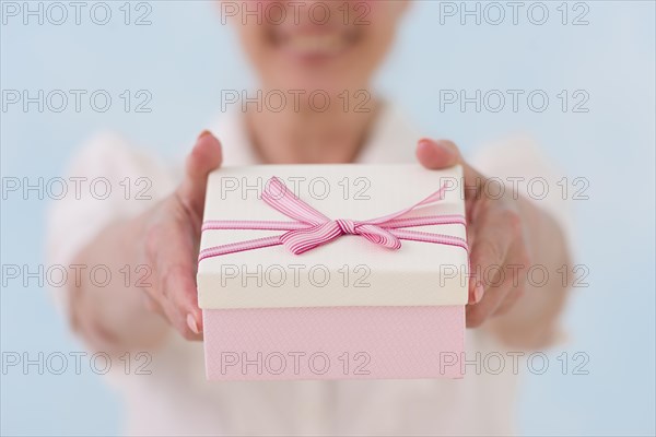 Close up woman s hand giving gift box