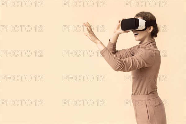 Copy space woman playing virtual reality headset