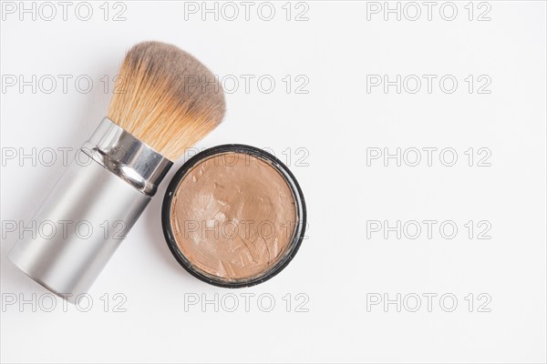 Cream foundation with brush white backdrop
