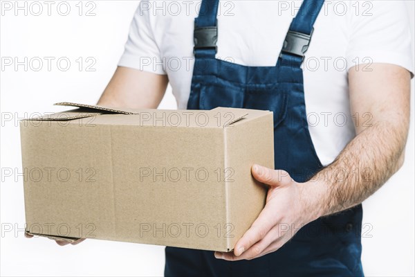 Crop deliveryman holding parcel