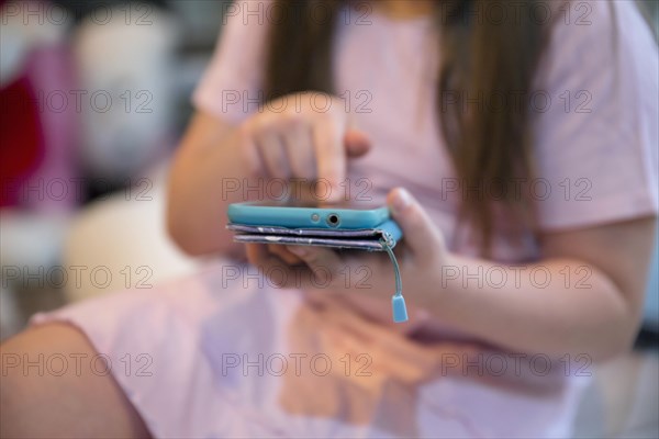 Crop girl browsing smartphone