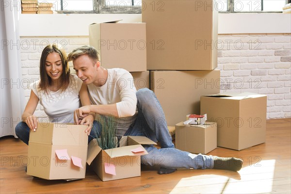 Curious man looking inside cardboard box