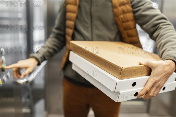 Delivery man with package elevator close up