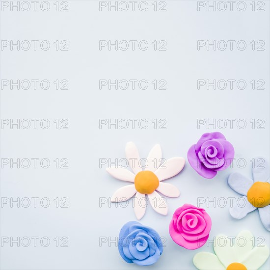 Different type clay flowers gray background