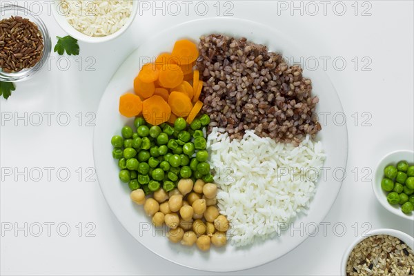 Different types porridge with vegetables plate with rice bowls table