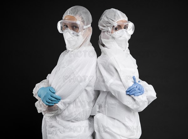 Doctors posing while wearing protective wear