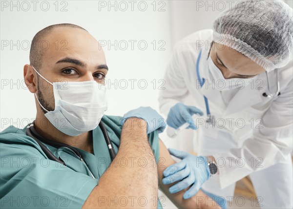 Doctor vaccinating patient clinic 3