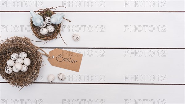 Easter inscription with quail eggs nests