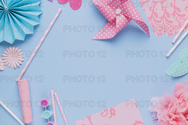 Elevated view origami crafts art straw blue background