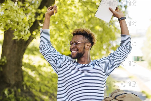 Excited black man posing with hand sup