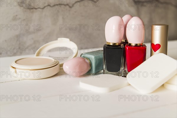 Face cosmetic compact makeup powder with sponges nail polish bottle lipstick table