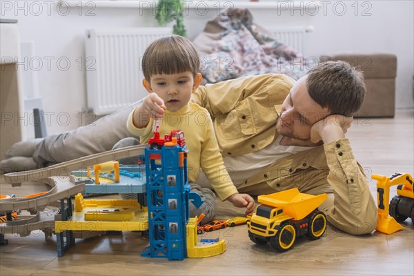 Father son playing with toy cars