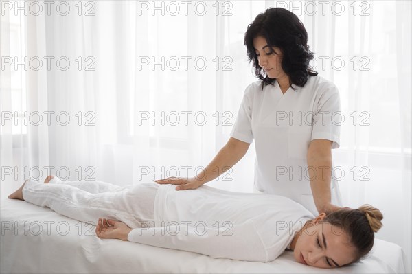 Female osteopathist treating girl hospital