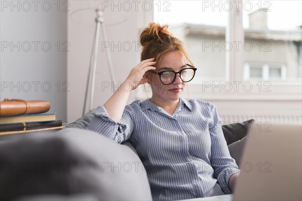 Female teacher couch home holding online class