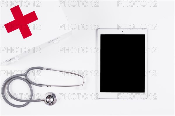 First aid kit stethoscope digital tablet white background