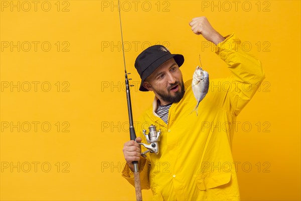Fisherman holding fishing rod looking catch