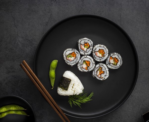 Flat lay maki sushi with rice chopsticks