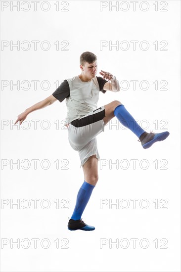 Footballer striking with his right leg