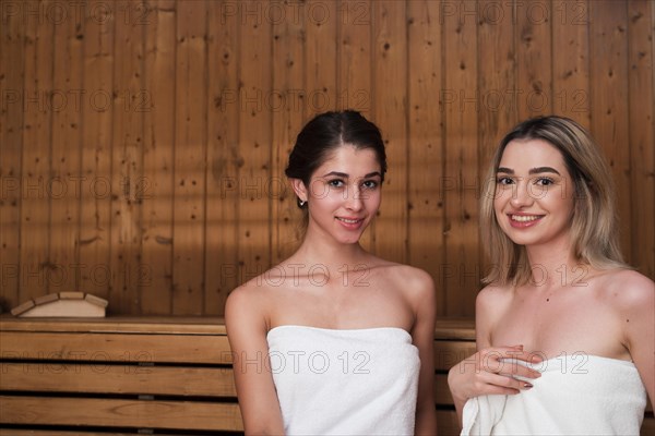 Friends posing relaxed sauna