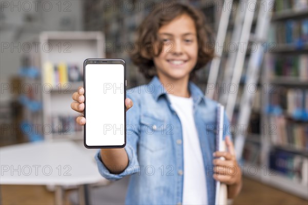 Front view boy holding empty screen phone library