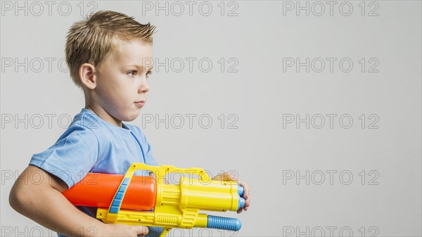 Front view child holding water gun