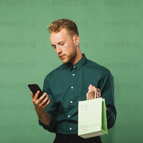 Front view male checking his phone