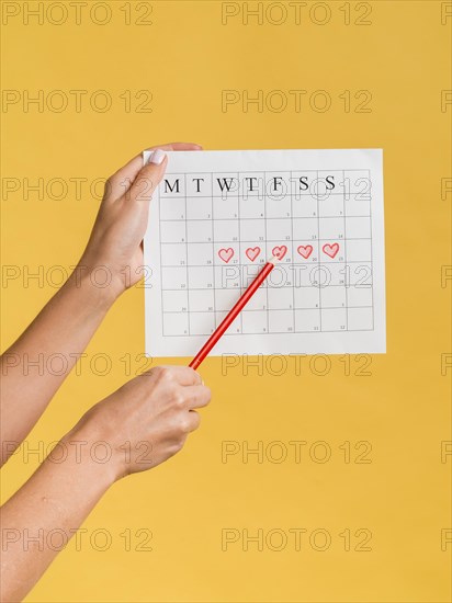 Front view menstruation calendar with hearts pencil